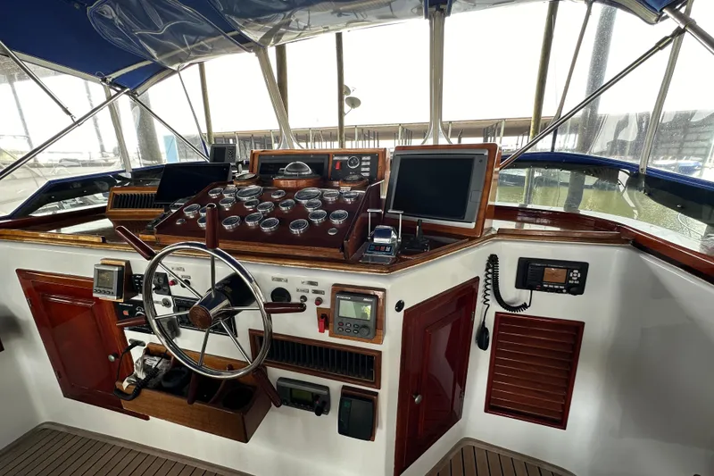 Slide: The Image of Helm of a 1980 Bertram 58 Convertible yacht with navigation instruments and steering wheel. - 21