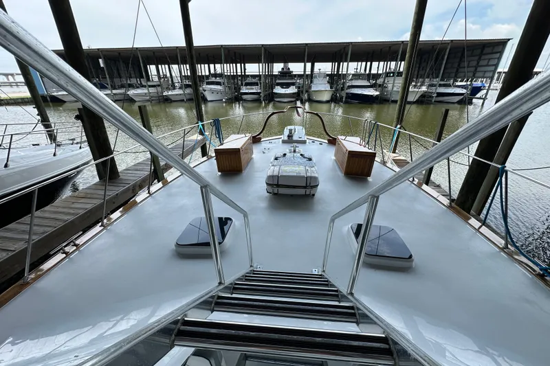 Slide: The Image of 1980 Bertram 58 Convertible yacht docked in a marina, view from the deck. - 28