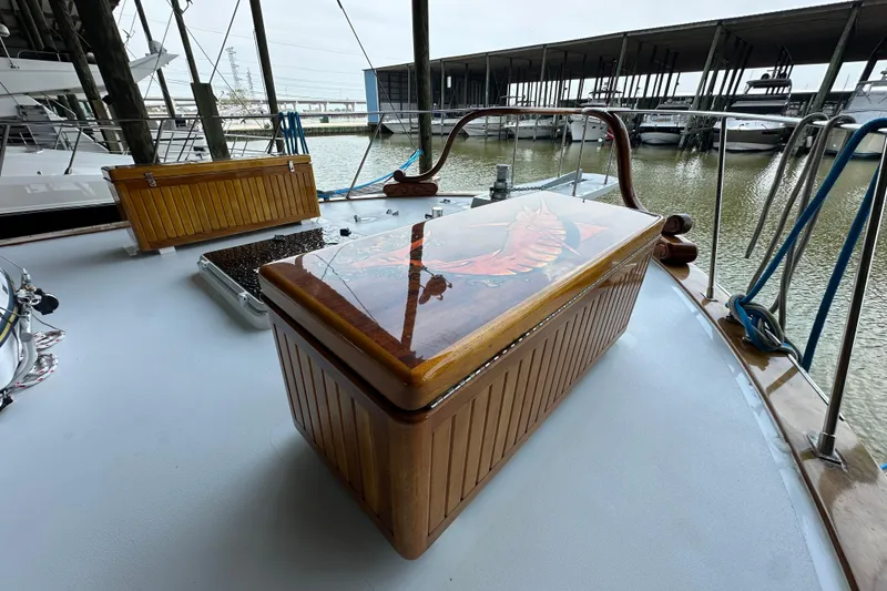 Slide: The Image of Wooden deck of 1980 Bertram 58 Convertible with decorative storage box. - 31
