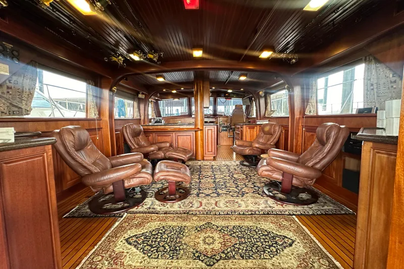 Slide: The Image of Luxurious interior of a 1980 Bertram 58 Convertible yacht with leather seating and elegant wood finishes. - 35