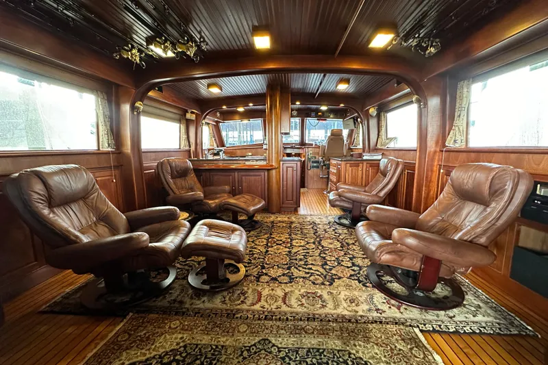 Slide: The Image of Luxurious interior of a 1980 Bertram 58 Convertible yacht with leather seating and wood paneling. - 36