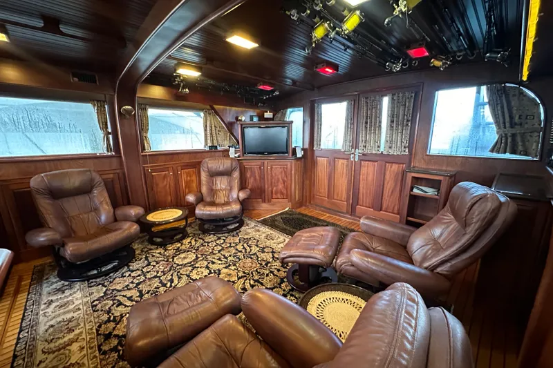 Slide: The Image of Luxurious interior of 1980 Bertram 58 Convertible yacht with leather seating and wood paneling. - 39