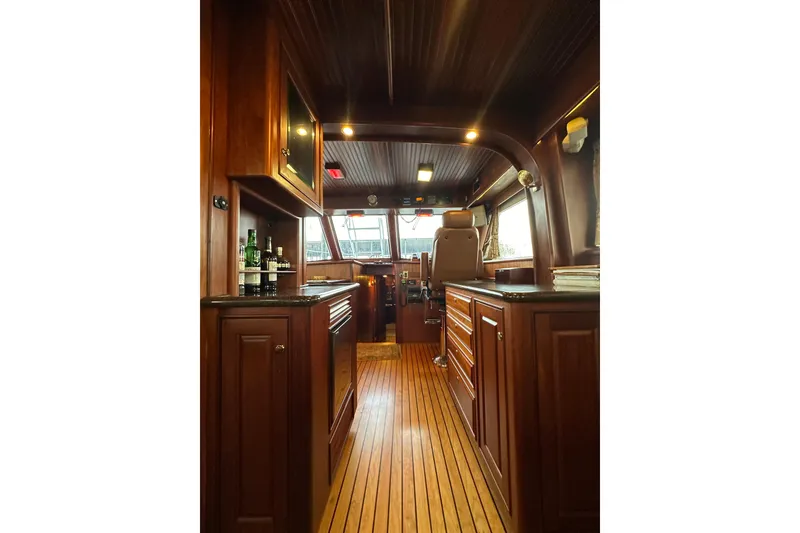 Slide: The Image of Interior of a 1980 Bertram 58 Convertible yacht with wooden cabinetry and flooring. - 41