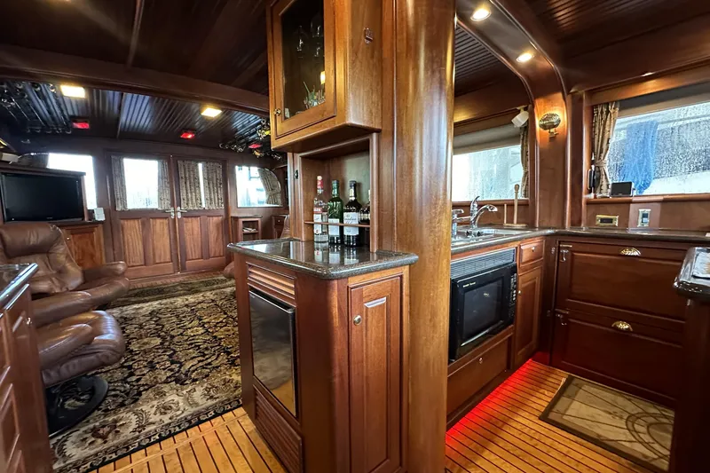 Slide: The Image of Luxurious interior of a 1980 Bertram 58 Convertible yacht with wood finishes and modern amenities. - 44