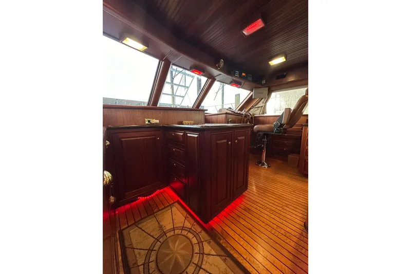 Slide: The Image of Luxurious interior of 1980 Bertram 58 Convertible yacht with wood finish and ambient lighting. - 47