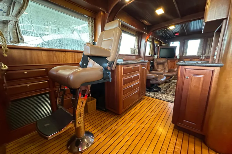 Slide: The Image of Luxurious interior of a 1980 Bertram 58 Convertible yacht with elegant wood finishes. - 54