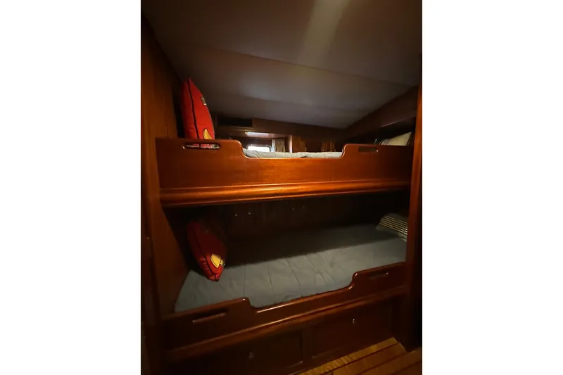 Slide: The Image of Bunk beds in a 1980 Bertram 58 Convertible yacht cabin with wooden finish. - 60