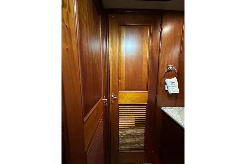 Slide: The Image of Wooden interior door on 1980 Bertram 58 Convertible yacht, with towel ring and granite countertop. - 63