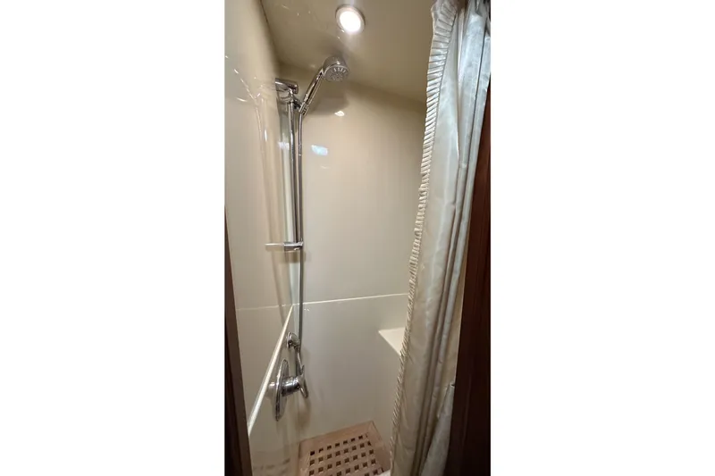 Slide: The Image of Compact shower area in a 1980 Bertram 58 Convertible yacht, featuring modern fixtures. - 64