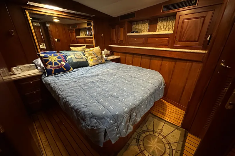 Slide: The Image of Luxurious cabin interior of a 1980 Bertram 58 Convertible yacht with nautical-themed decor. - 65