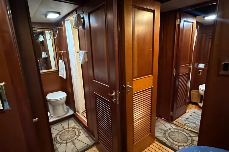 Slide: The Image of Interior of 1980 Bertram 58 Convertible yacht featuring wooden doors and bathroom amenities. - 70