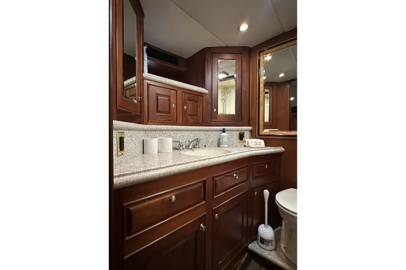 Slide: The Image of Luxurious bathroom interior of 1980 Bertram 58 Convertible yacht with wooden cabinetry. - 72