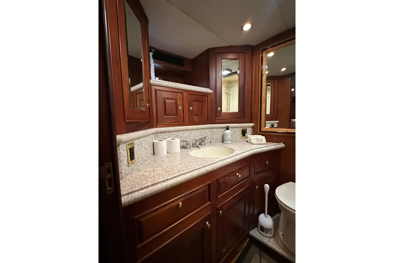 Slide: The Image of Luxurious bathroom interior of 1980 Bertram 58 Convertible yacht with wooden cabinetry. - 73
