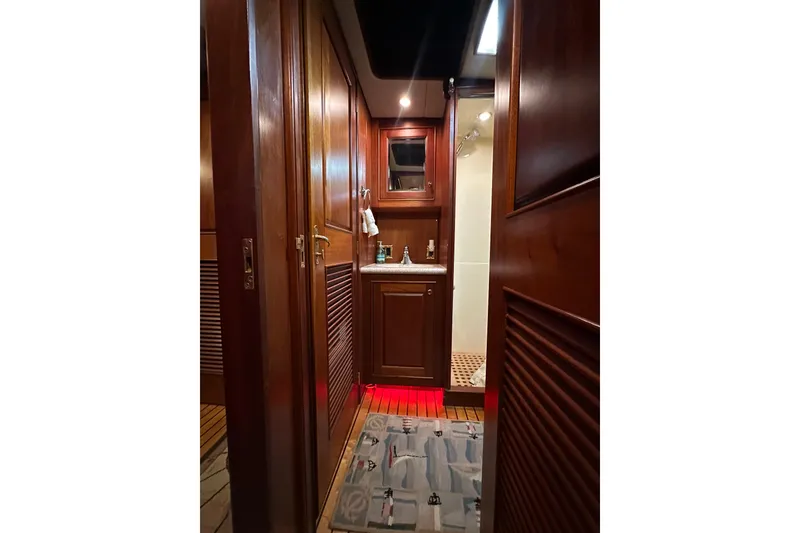 Slide: The Image of Interior of 1980 Bertram 58 Convertible yacht with wooden cabinetry and nautical-themed decor. - 76