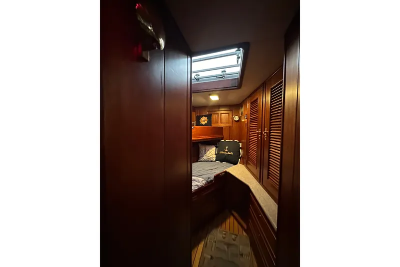 Slide: The Image of Cozy cabin interior of 1980 Bertram 58 Convertible yacht with wooden paneling. - 78