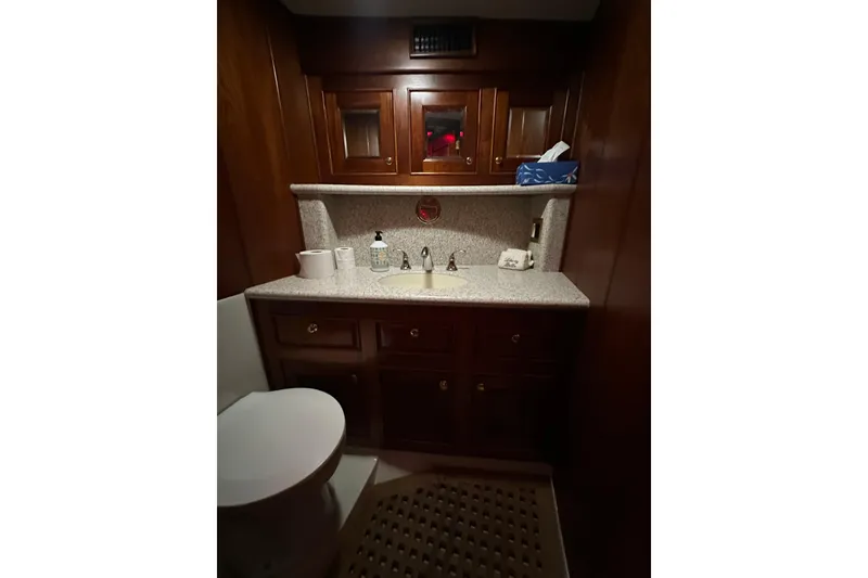 Slide: The Image of Luxurious bathroom interior of a 1980 Bertram 58 Convertible yacht with wooden cabinetry. - 80