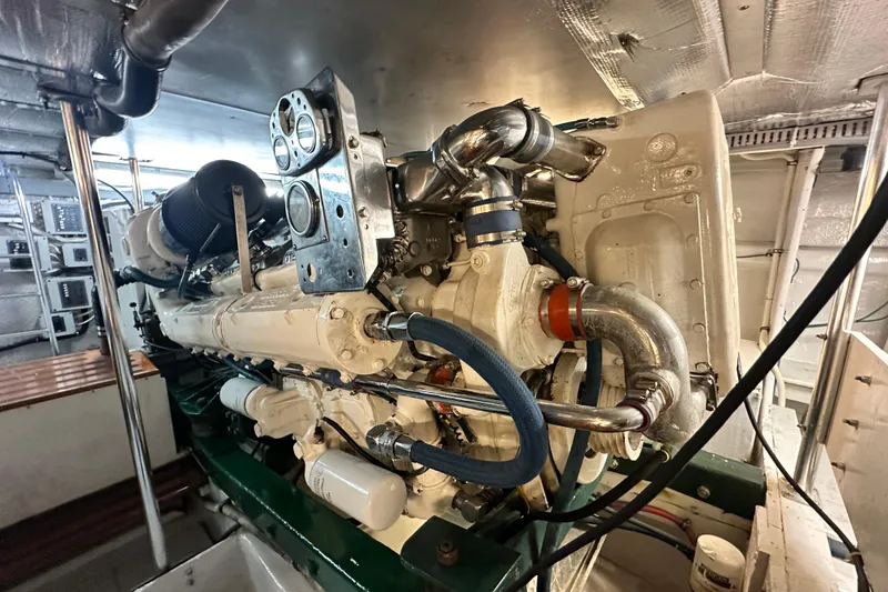 Slide: The Image of Engine room of a 1980 Bertram 58 Convertible yacht, showcasing detailed machinery. - 86