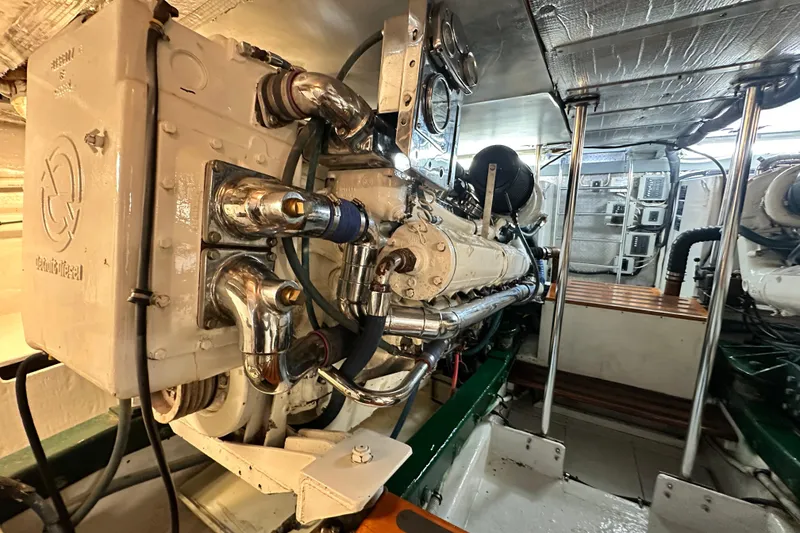 Slide: The Image of Engine room of a 1980 Bertram 58 Convertible yacht, showcasing detailed machinery and components. - 87
