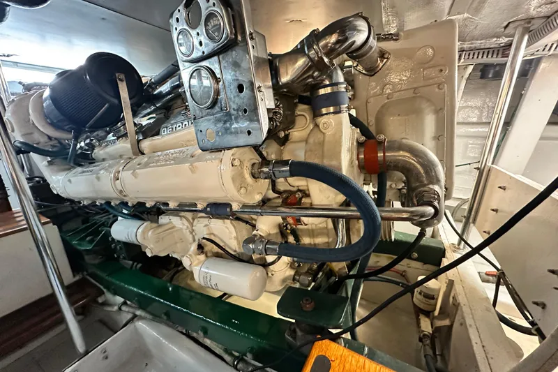 Slide: The Image of Engine room of a 1980 Bertram 58 Convertible yacht, showcasing detailed machinery. - 90