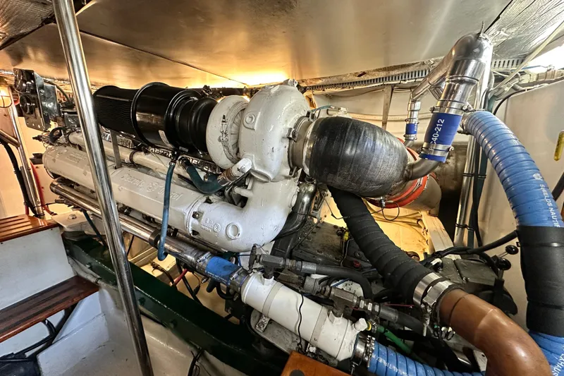 Slide: The Image of Engine room of a 1980 Bertram 58 Convertible yacht, showcasing detailed machinery. - 95