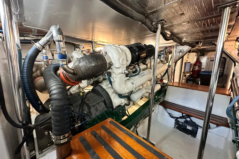 Slide: The Image of Engine room of a 1980 Bertram 58 Convertible yacht, showcasing machinery and components. - 96