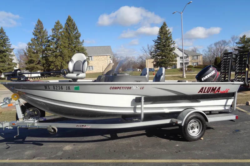 The Image of 2015 Alumacraft Competitor 165 CS fishing boat on trailer, parked outdoors. - 0