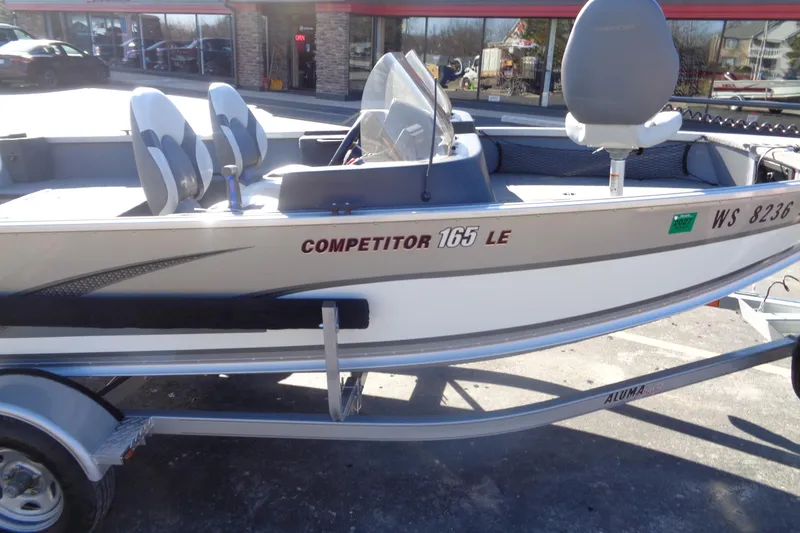 Slide: The Image of 2015 Alumacraft Competitor 165 CS boat on trailer, parked outside a store. - 11
