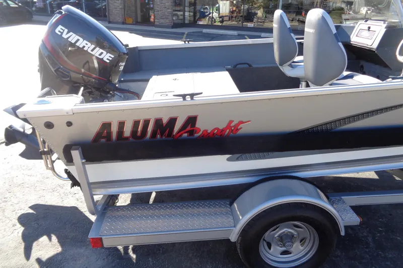 Slide: The Image of 2015 Alumacraft Competitor 165 CS boat with Evinrude motor on trailer. - 12