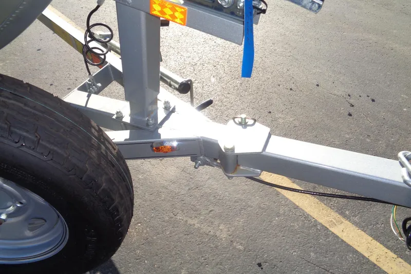 Slide: The Image of Trailer hitch and tire of 2015 Alumacraft Competitor 165 CS boat on pavement. - 15