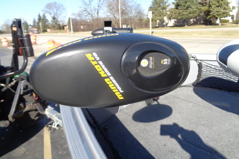 Slide: The Image of Minn Kota trolling motor on 2015 Alumacraft Competitor 165 CS boat, parked outdoors. - 19