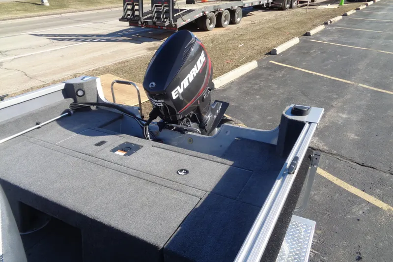 Slide: The Image of 2015 Alumacraft Competitor 165 CS boat with Evinrude outboard motor in parking lot. - 23