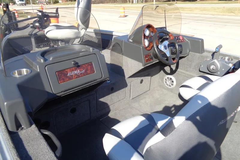 Slide: The Image of 2015 Alumacraft Competitor 165 CS boat interior with steering console and seating. - 24