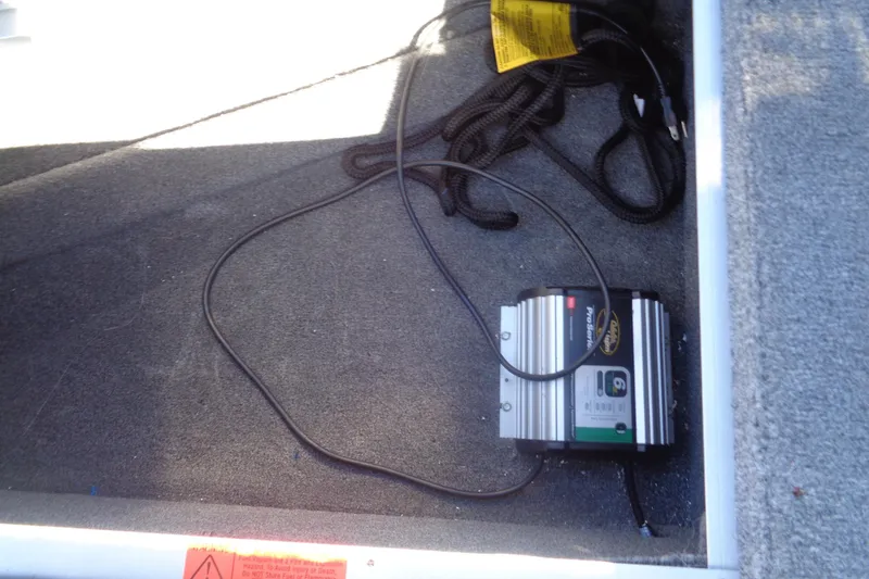 Slide: The Image of Onboard battery charger in 2015 Alumacraft Competitor 165 CS boat compartment. - 26