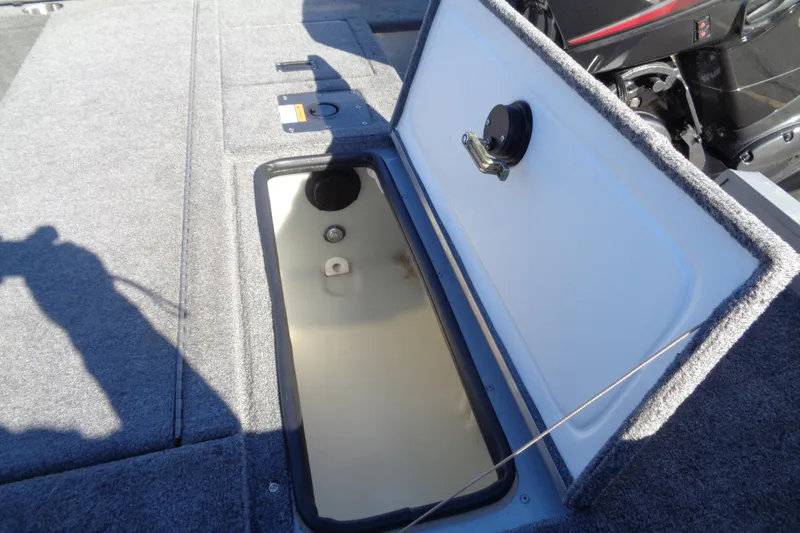 Slide: The Image of 2015 Alumacraft Competitor 165 CS boat storage compartment open, showing interior details. - 27