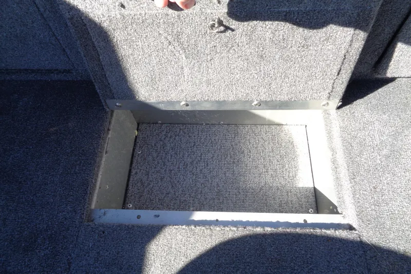 Slide: The Image of 2015 Alumacraft Competitor 165 CS boat storage compartment with open hatch. - 28