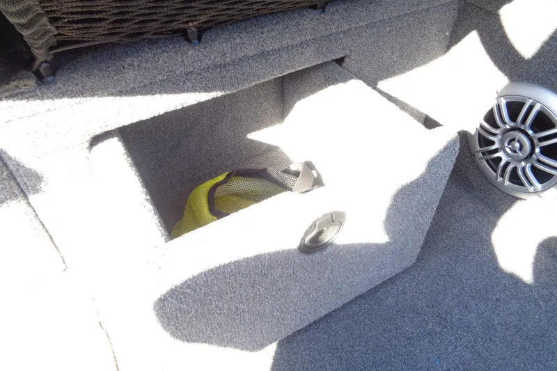 Slide: The Image of Storage compartment in 2015 Alumacraft Competitor 165 CS boat with speaker and gear bag. - 29