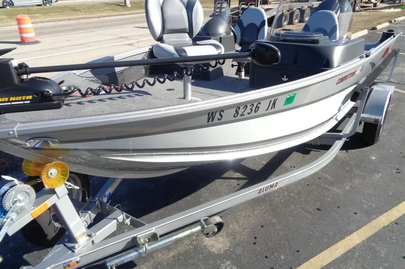 Slide: The Image of 2015 Alumacraft Competitor 165 CS fishing boat on trailer, parked outdoors. - 5