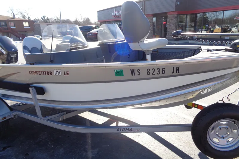 Slide: The Image of 2015 Alumacraft Competitor 165 CS boat on trailer, parked outdoors. - 6
