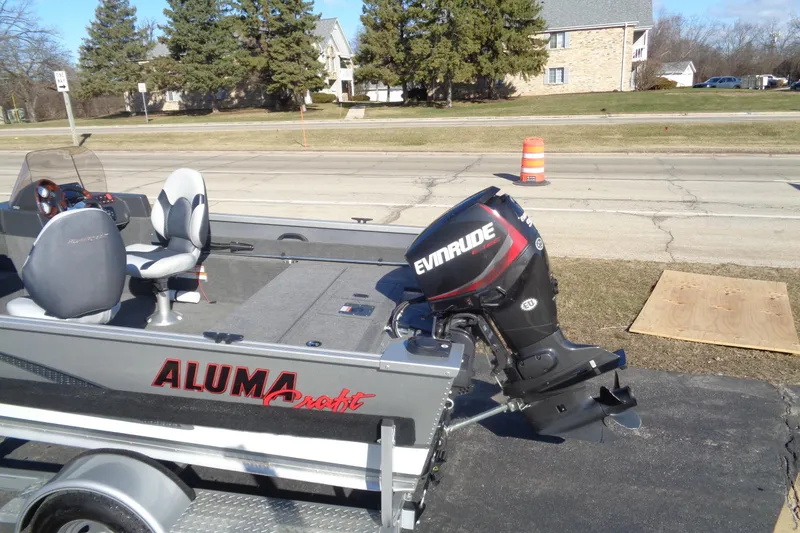 Slide: The Image of 2015 Alumacraft Competitor 165 CS boat with Evinrude motor on trailer. - 8