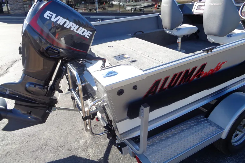 Slide: The Image of 2015 Alumacraft Competitor 165 CS boat with Evinrude motor, parked on trailer. - 9