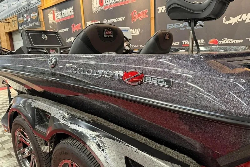 Slide: The Image of 2021 Ranger Z520L boat displayed indoors with branded backdrop. - 14