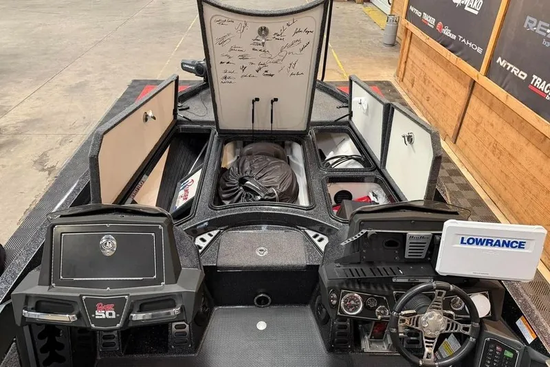 Slide: The Image of 2021 Ranger Z520L boat interior with open storage compartments and Lowrance electronics. - 15
