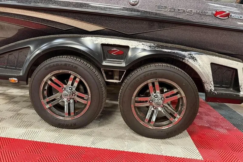 Slide: The Image of 2021 Ranger Z520L boat trailer with dual wheels on a patterned floor. - 18