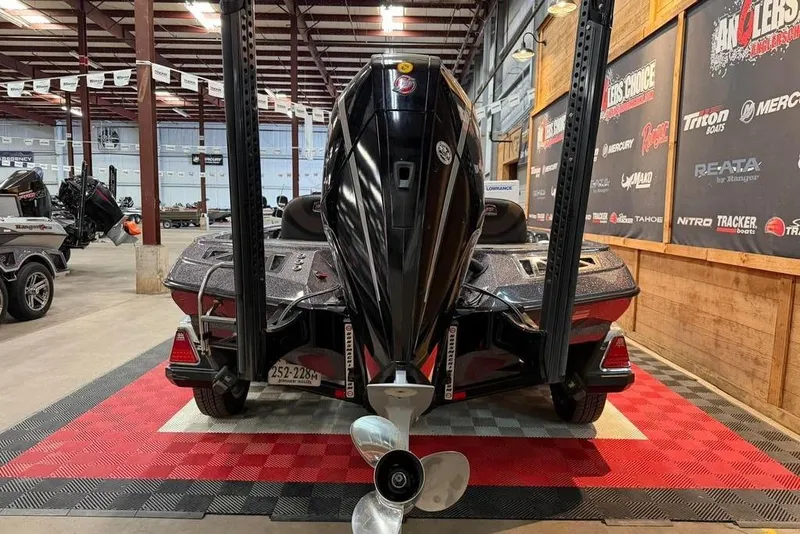 Slide: The Image of 2021 Ranger Z520L boat displayed indoors, showcasing rear view and motor. - 6
