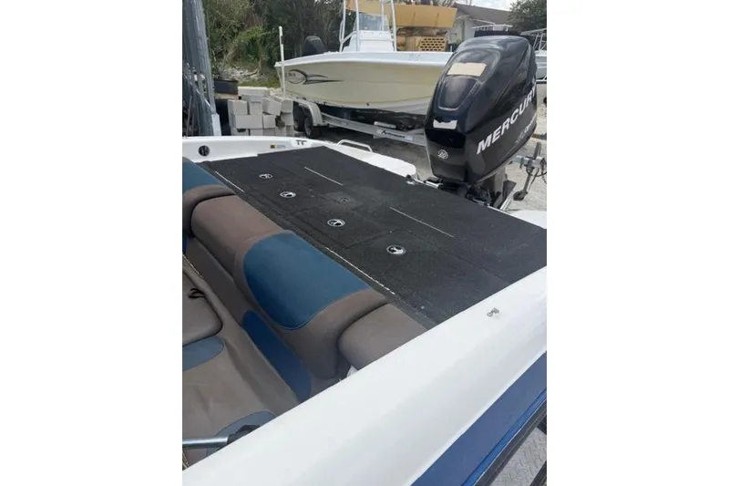 Slide: The Image of 2008 Champion 214 SX boat with Mercury outboard motor, featuring spacious seating and deck. - 10