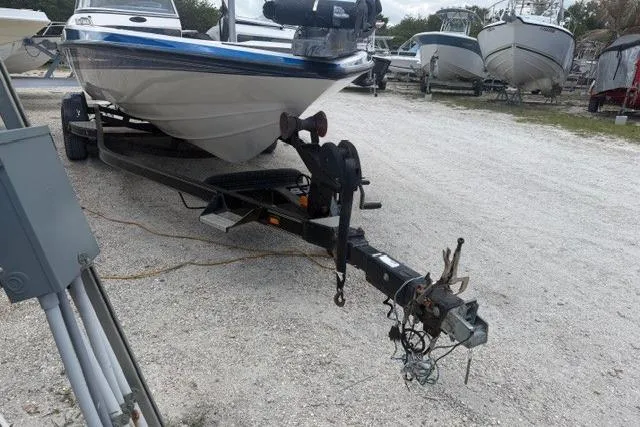 Slide: The Image of 2008 Champion 214 SX boat on trailer in outdoor storage area. - 4