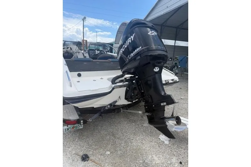 Slide: The Image of 2008 Champion 214 SX boat with Mercury OptiMax outboard motor on trailer. - 6