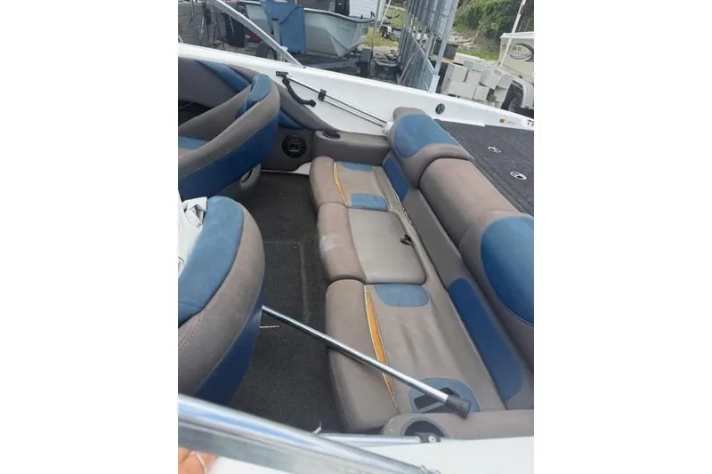 Slide: The Image of 2008 Champion 214 SX boat interior with blue and gray seating, showcasing spacious design. - 9