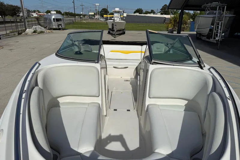 Slide: The Image of 2002 Chaparral 220 SSi boat interior with white seating and open windshield. - 10
