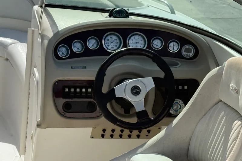 Slide: The Image of 2002 Chaparral 220 SSi boat dashboard with steering wheel and instrument panel. - 11